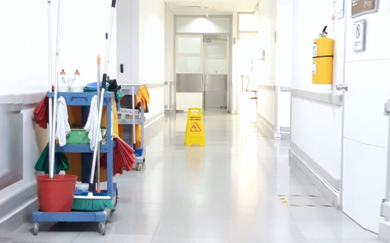 A hospital corridor with cleaning equipment